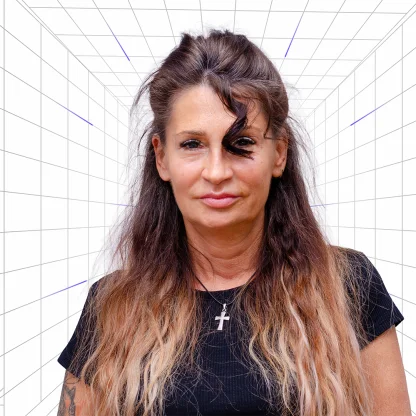 Portrait of a woman with long wavy brown hair, wearing a black shirt and a cross necklace, against a white grid background.  eClick Apps